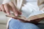 closeup of woman turning the page of a book