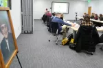 group of people sitting in a conference room