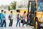 line of students getting on school bus
