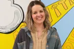 Portrait of Katie Weiner, an instructional paraprofessional at Thompson Elementary School and a finalist for North Dakota United's 2027 Education Support Professional of the Year. She smiles in front of a colorful school mural.