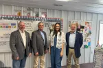 Rep. Dave Rustebakke, Sen. Randy Lemm and Rep. Mike Beltz stand with 2026 North Dakota Teacher of the Year Frannie Tunseth in her classroom at May-Port CG Middle School during a visit to observe teaching and learning.