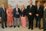 North Dakota Gov. Kelly Armstrong, finalist Jennifer Yokes, 2027 ND Teacher of the Year Brian Schneider, finalist Teresa Olson, finalist Dustin Moe, ND United President Nick Archuleta and ND Superintendent of Public Instruction Levi Bachmeier stand together for a photo in the state Capitol. 