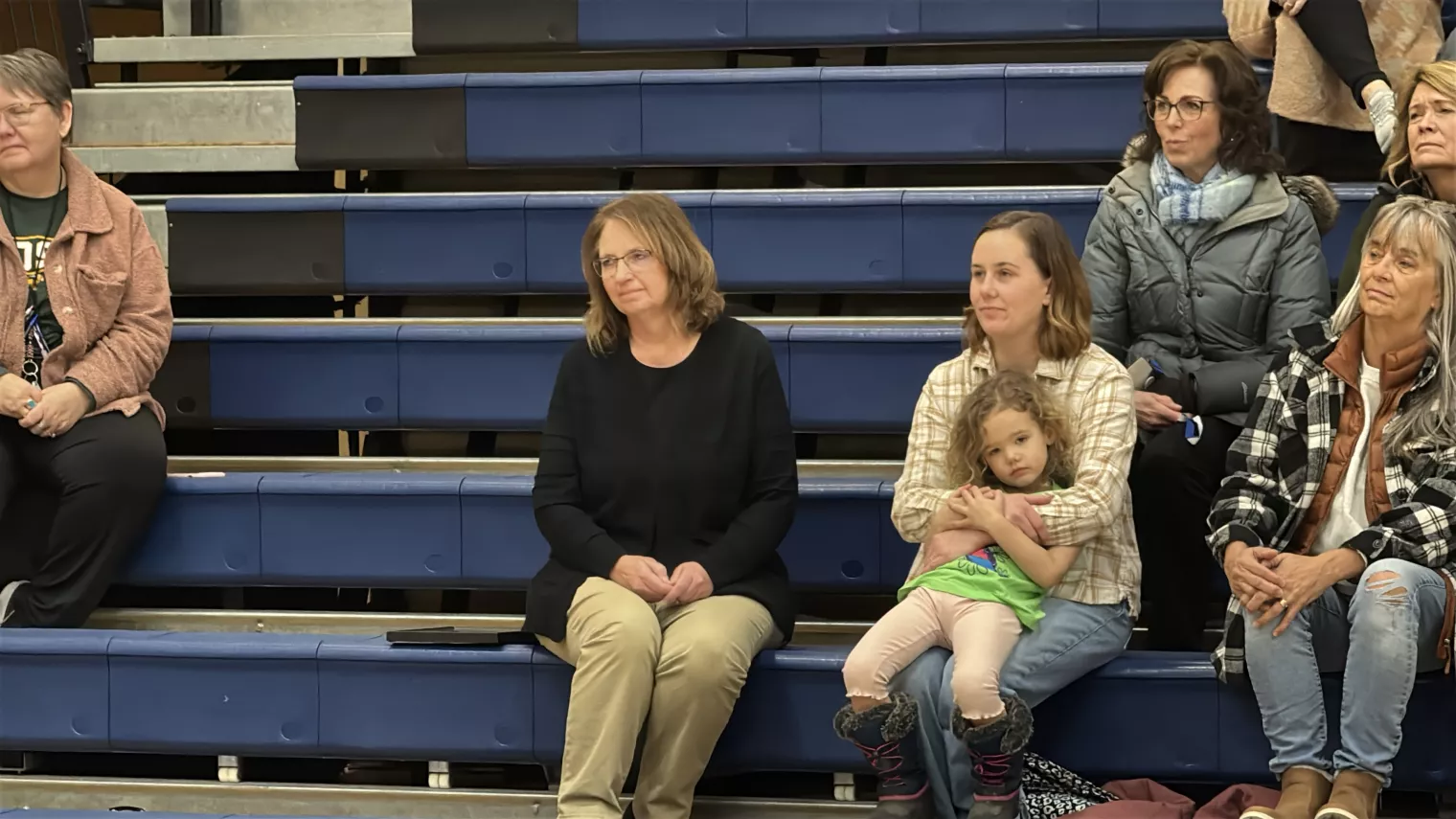 ESP of the Year finalist Brenda Muller sits in stands with family and the elementary school students at her award ceremony.