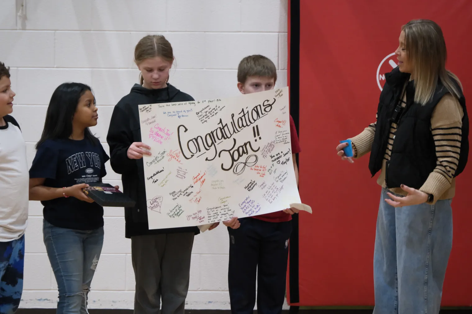 group of students holding a congrats sign