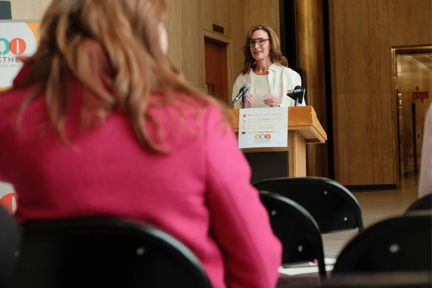 A speaker addresses attendees at a press conference in the state Capitol.