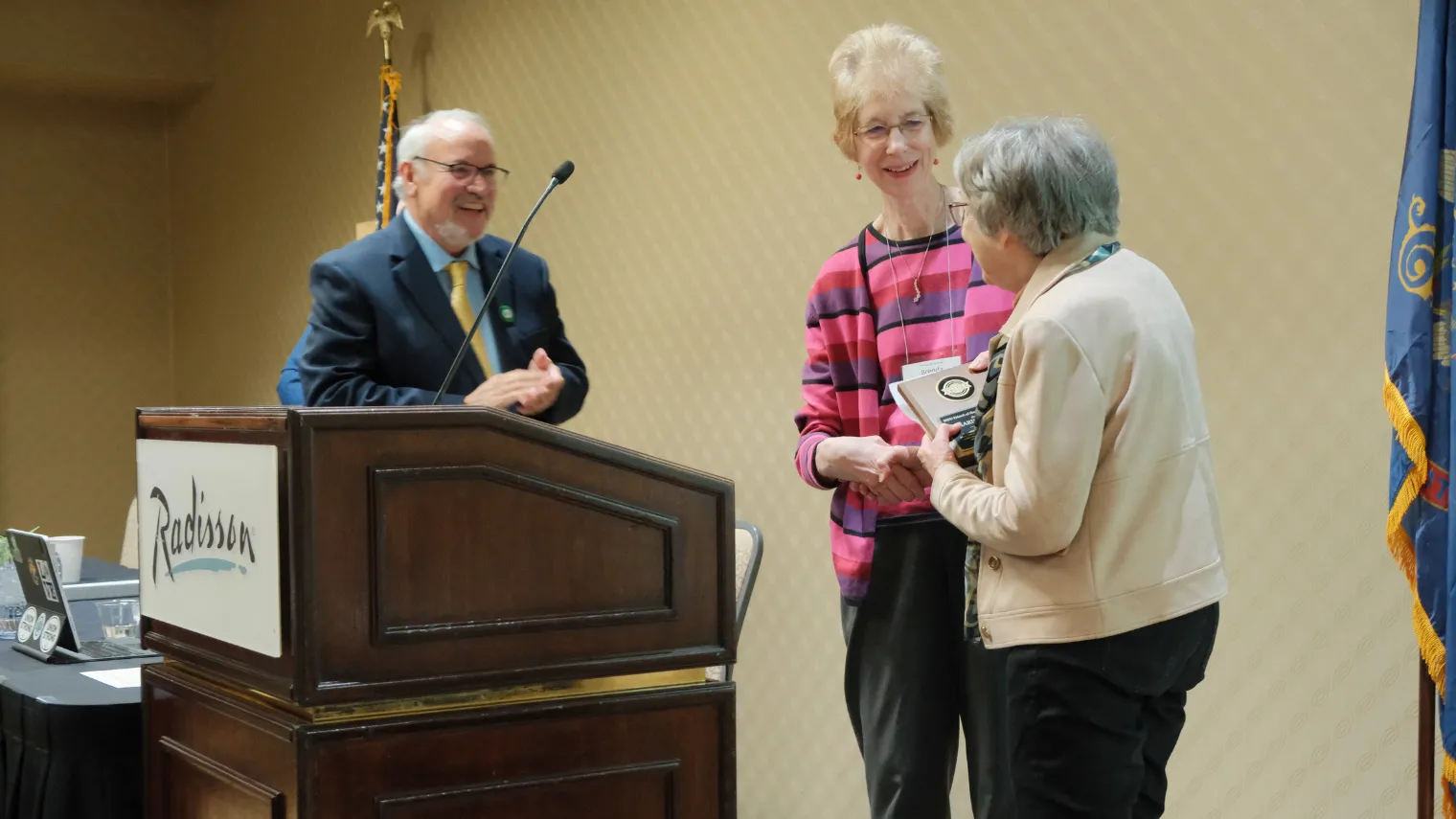 North Dakota United Foundation Chair Brenda Seehafer presents a Friend of the Foundation award to Marie Snavely during the 2026 Delegate Assembly.