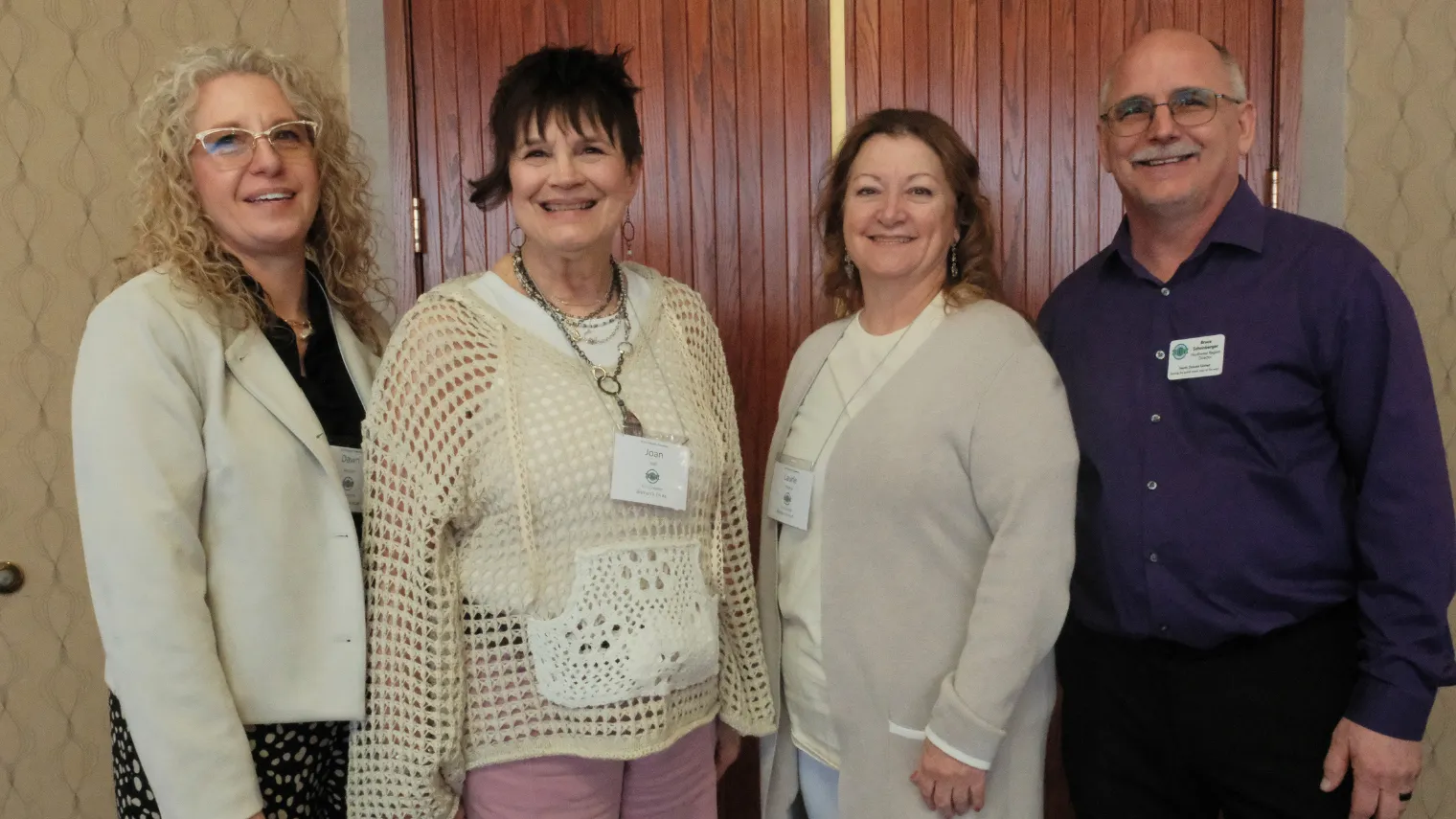 North Dakota United Education Support Professional of the Year Dawn Ressler poses with past ND United  Education Support Professionals of the Year during the 2026 Delegate Assembly.