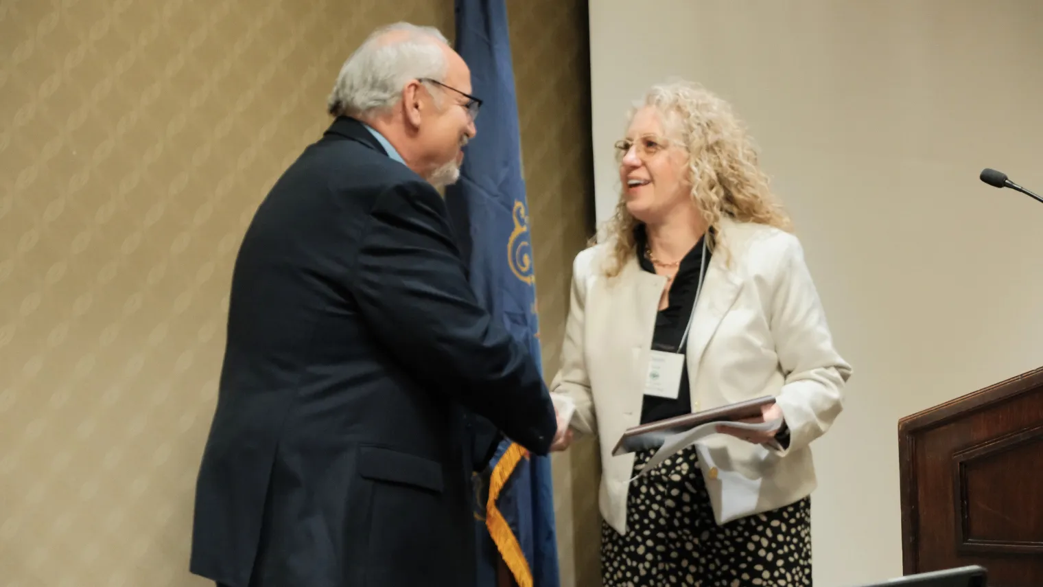 North Dakota United President Nick Archuleta presents the 2027 Education Support Professional of the Year award to Dawn Ressler during the 2026 Delegate Assembly.