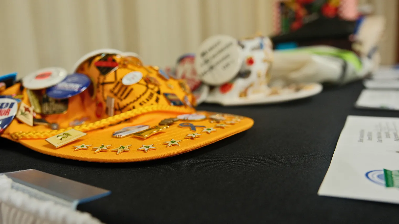 North Dakota United-themed buttons, stickers and other items are displayed on a table during the 2026 Delegate Assembly.