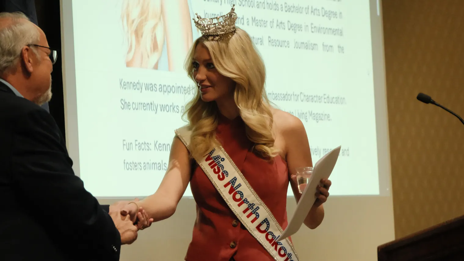 Miss North Dakota Kennedy DeLap is greeted by NDU President Nick Archuleta during the 2026 North Dakota United Delegate Assembly.