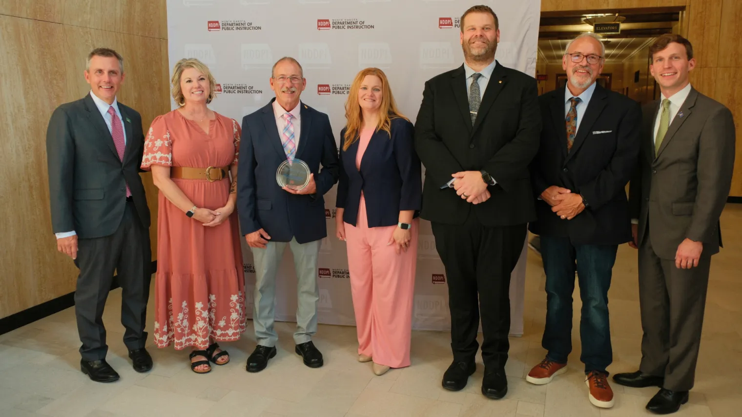 North Dakota Gov. Kelly Armstrong, finalist Jennifer Yokes, 2027 ND Teacher of the Year Brian Schneider, finalist Teresa Olson, finalist Dustin Moe, ND United President Nick Archuleta and ND Superintendent of Public Instruction Levi Bachmeier stand together for a photo in the state Capitol. 