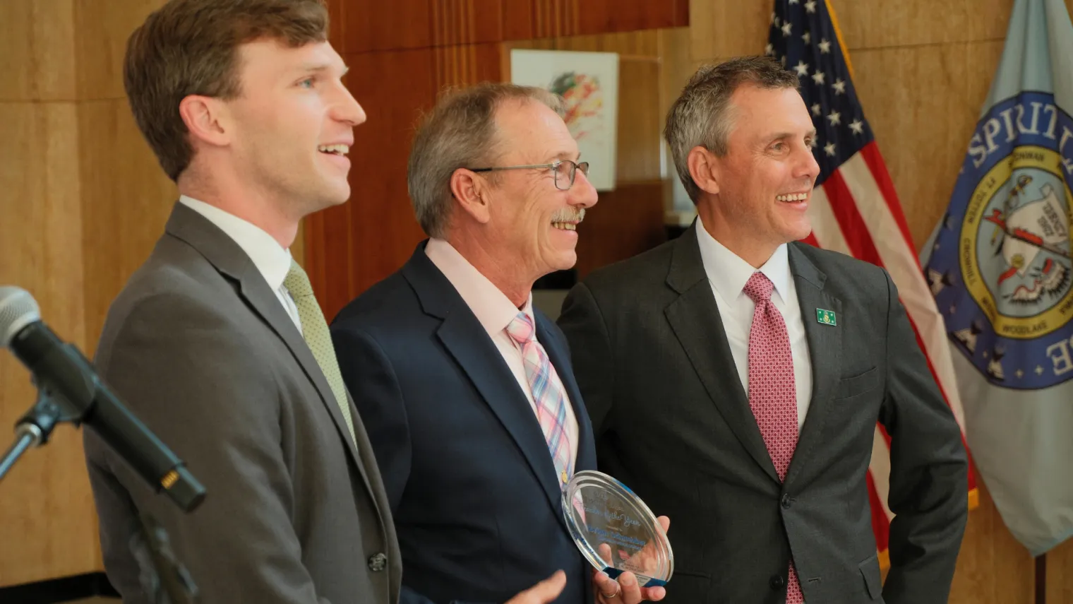 North Dakota Superintendent Levi Bachmeier, Teacher of the Year Brian Schneider and Gov. Kelly Armstrong pose for photos at the state Capitol. 