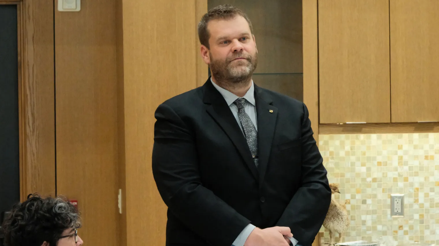 2027 North Dakota Teacher of the Year finalist Dustin Moe stands for recognition at a luncheon in the Governor's Residence. 