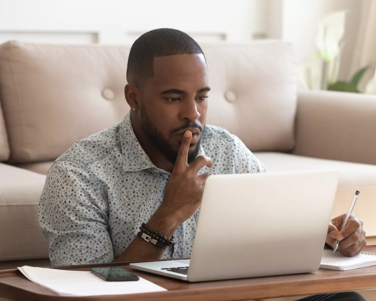 man sitting on the floor looking at his computer