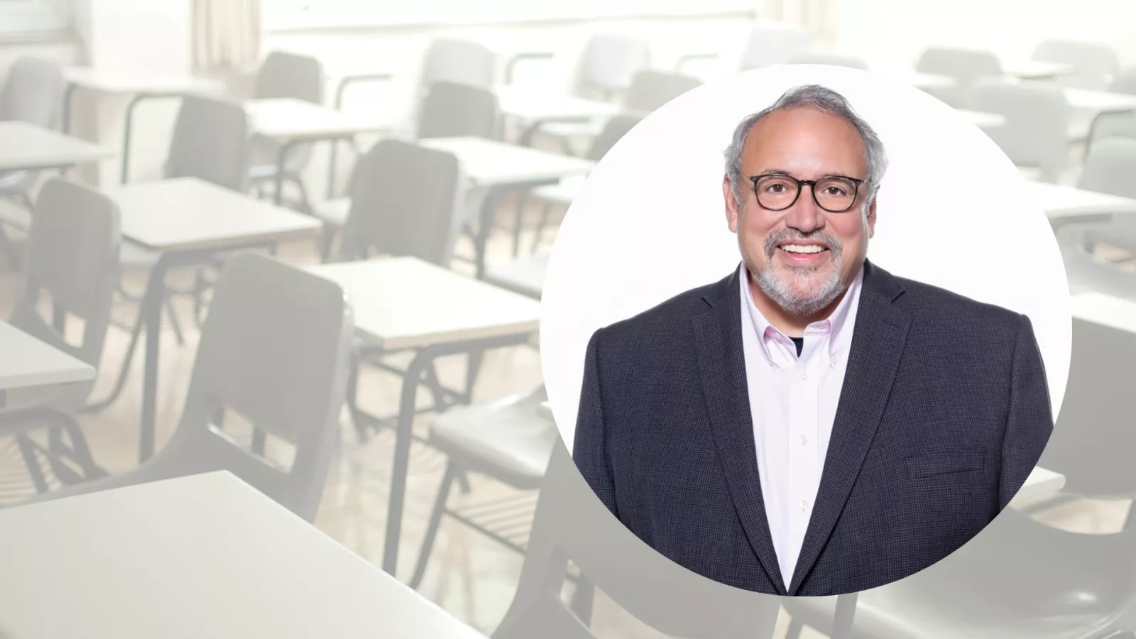 Background image of a classroom at 50% transparency, with circle image over it of a man wearing glasses and a suit.