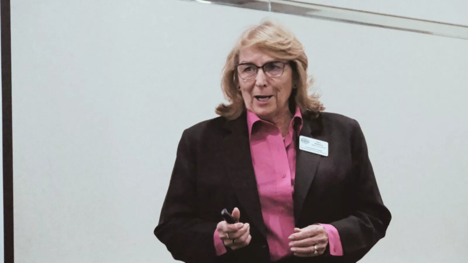 image of woman wearing glasses wearing pink dress shirt