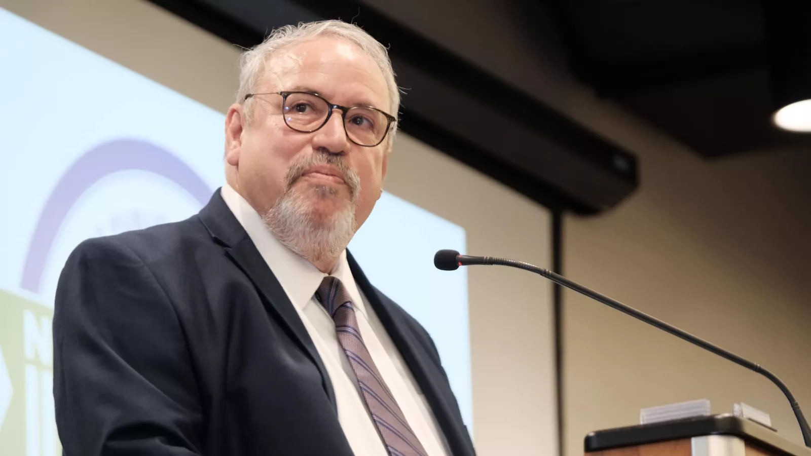 North Dakota United President	Nick Archuleta stands in front of a microphone.