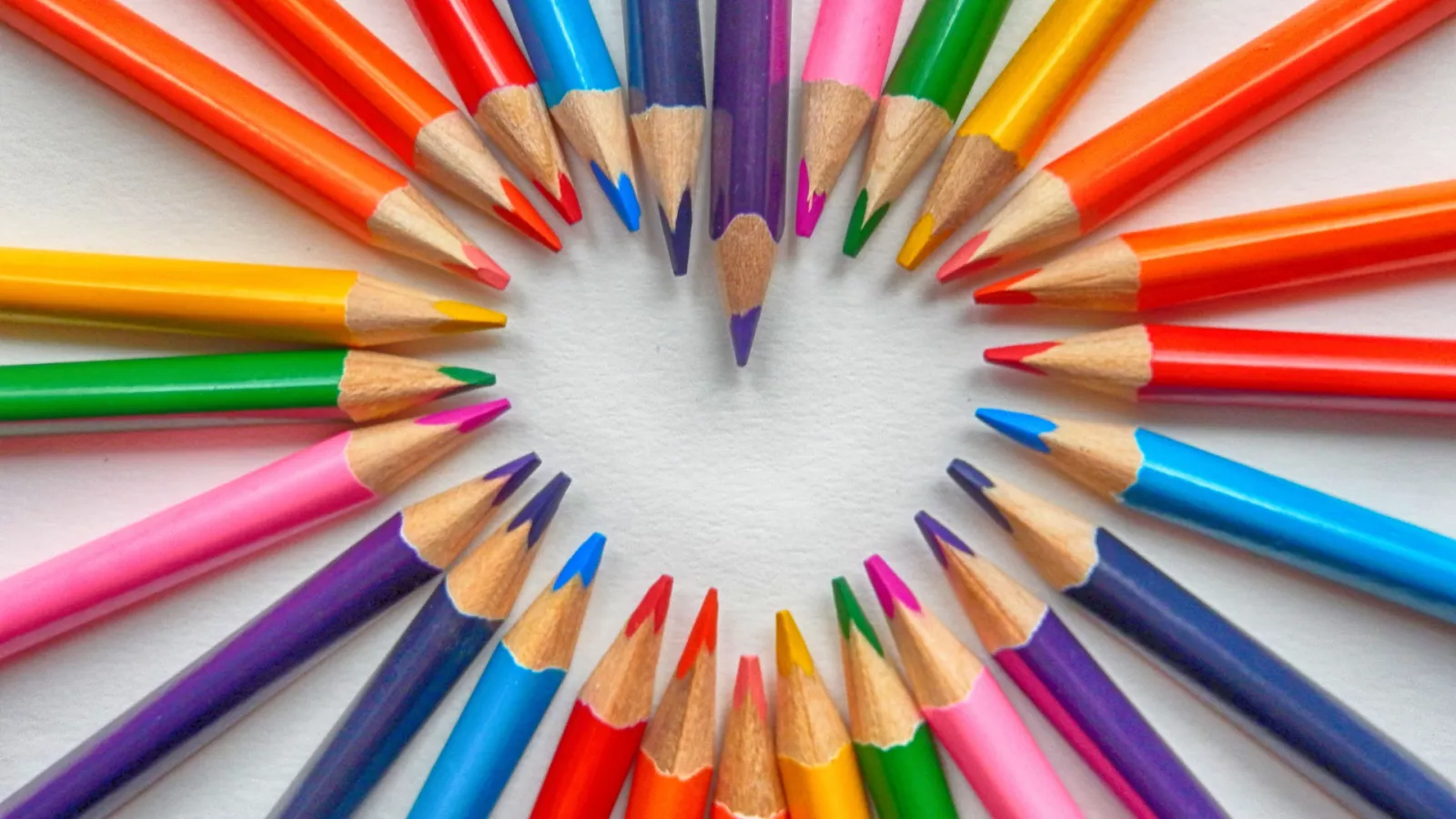colored pencils arranged in the shape of a heart