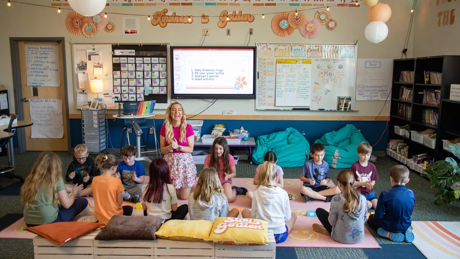 students sitting on classroom floor with teacher