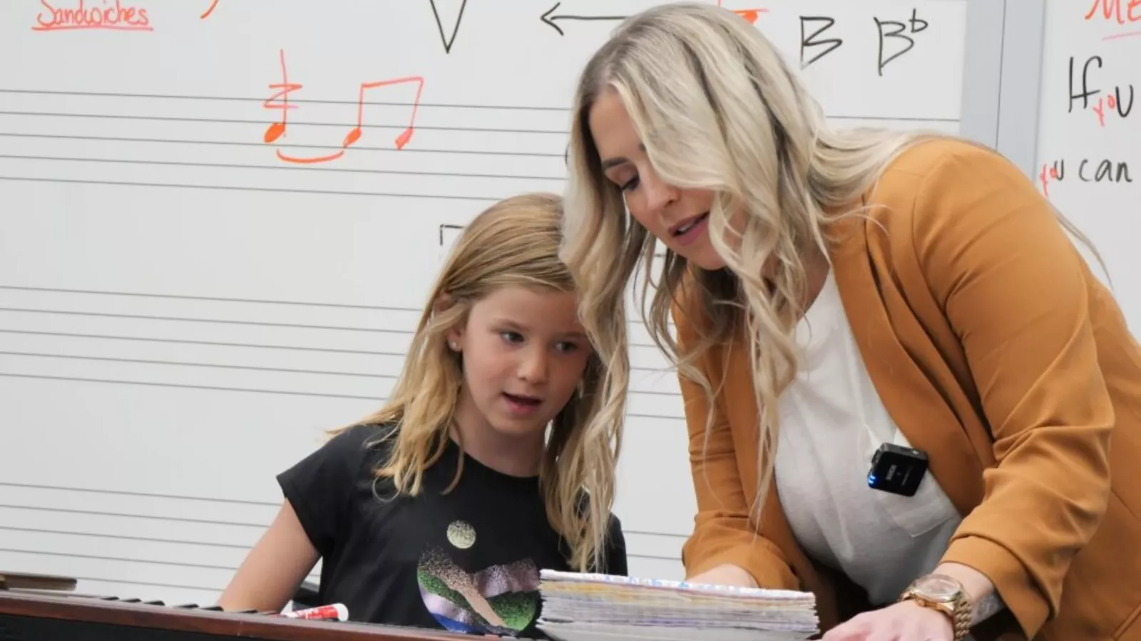 Minot elementary music instructor Risha Allen works one-on-one with a student in her classroom.