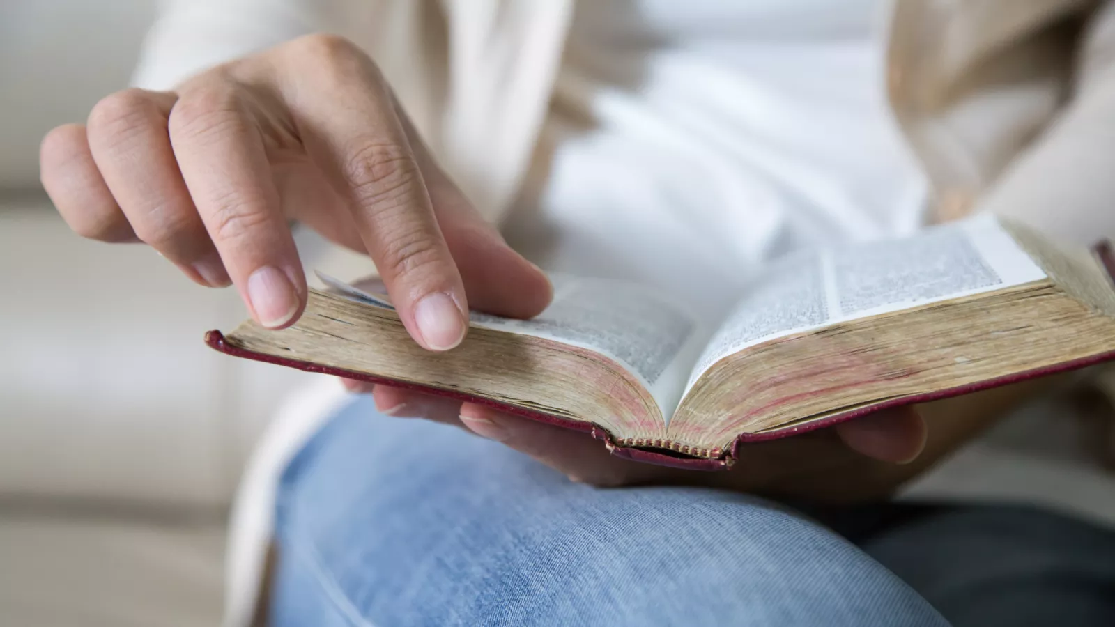 closeup of woman turning the page of a book