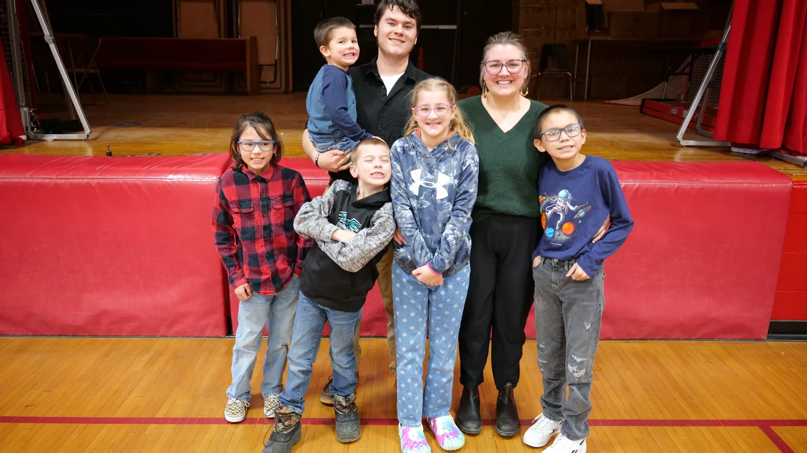 Dustin Brunner smiles with his wife and five kids