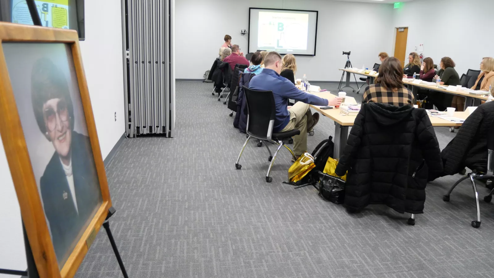 group of people sitting in a conference room