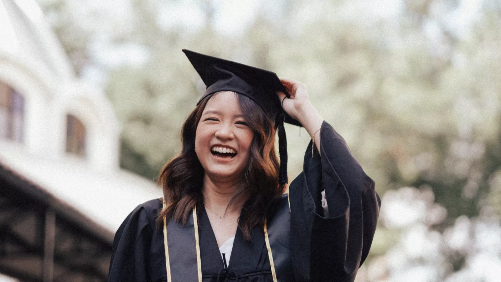 woman wearing graduation cap and gown