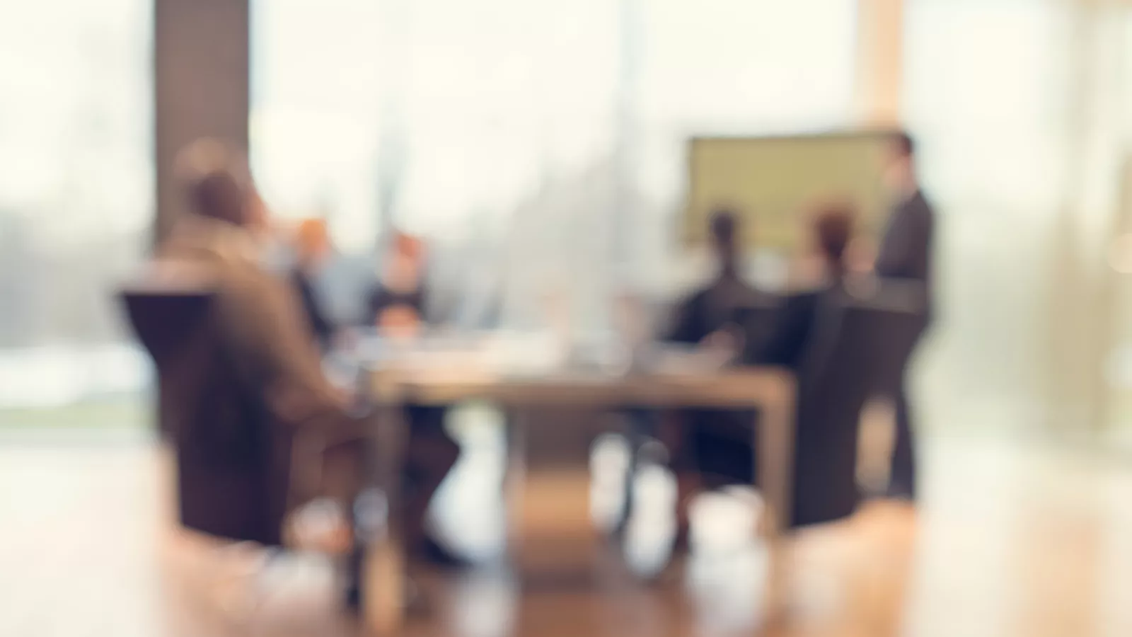 image of people sitting at a table in a meeting room