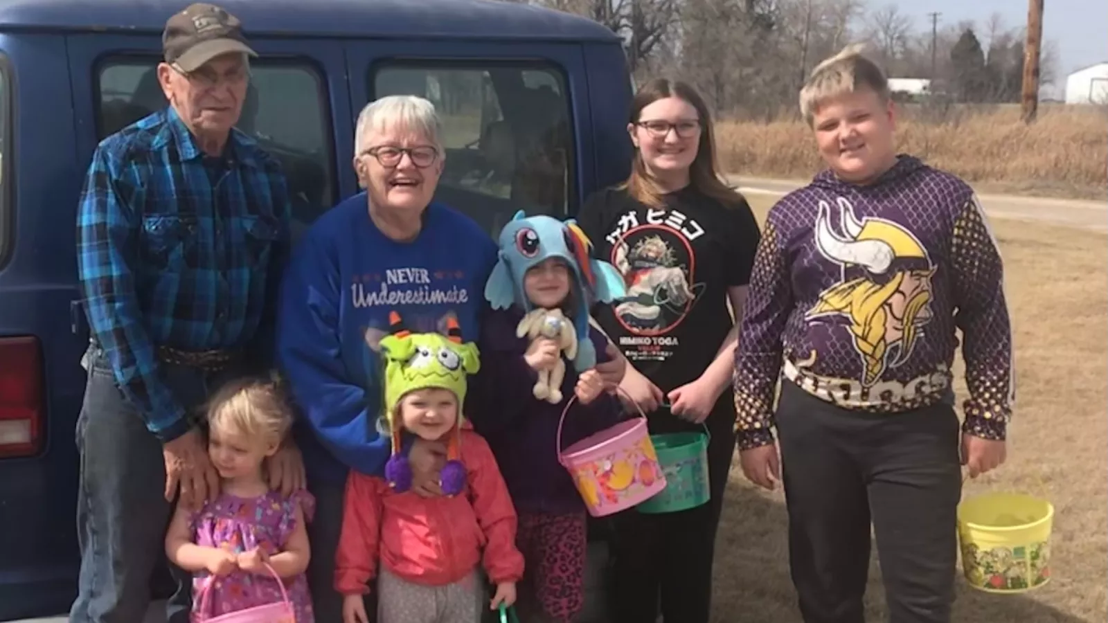 kids standing with grand parents outside in the fall