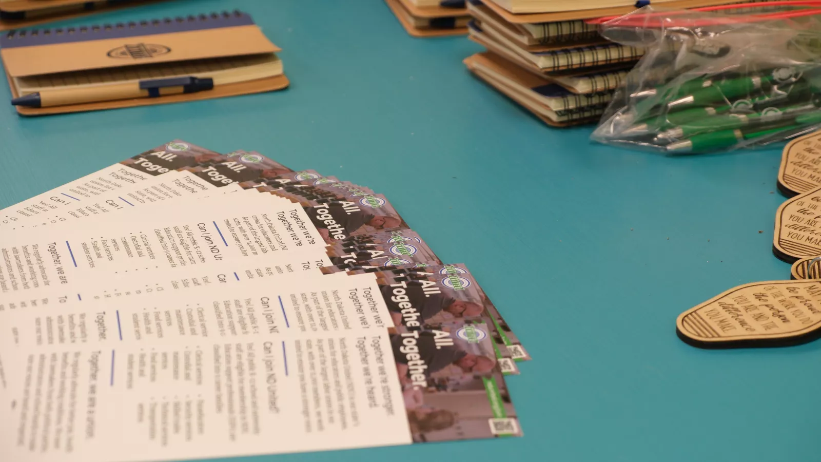 brochures fanned out on a table at a conference