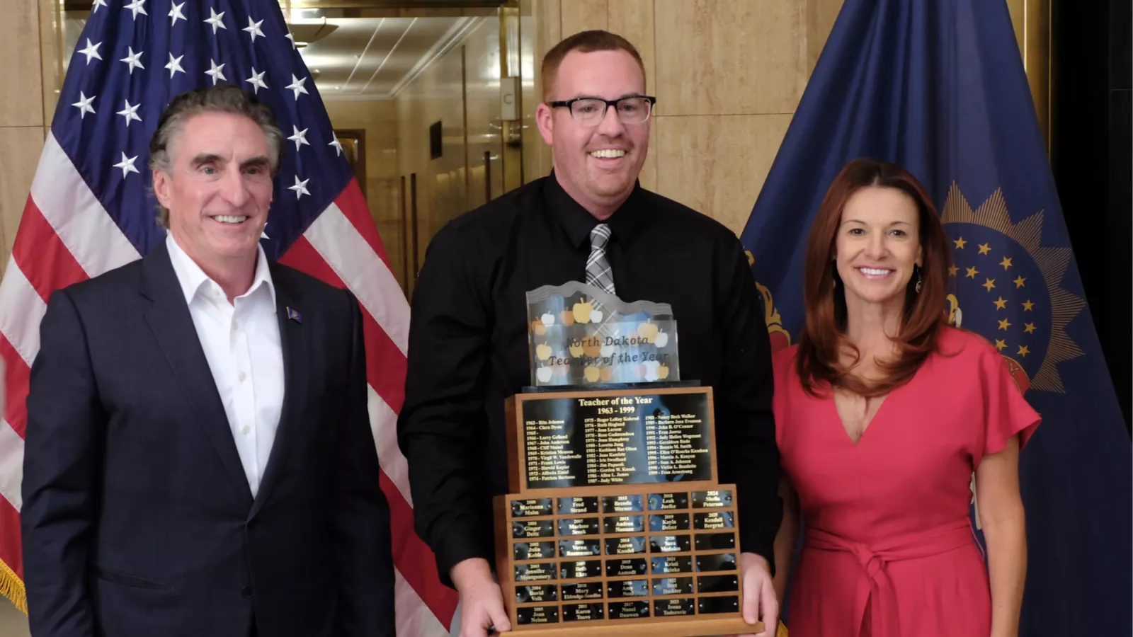 ND teacher of the year Kendall Bergrud holding the trophy