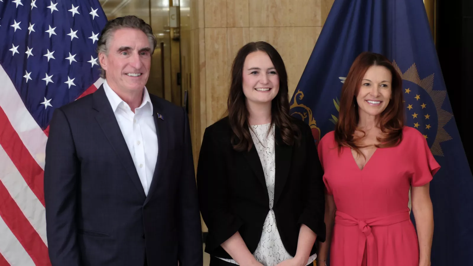 ND TOY finalist, Ashley Nudell standing with Gov. Burgum and Kristi Baesler