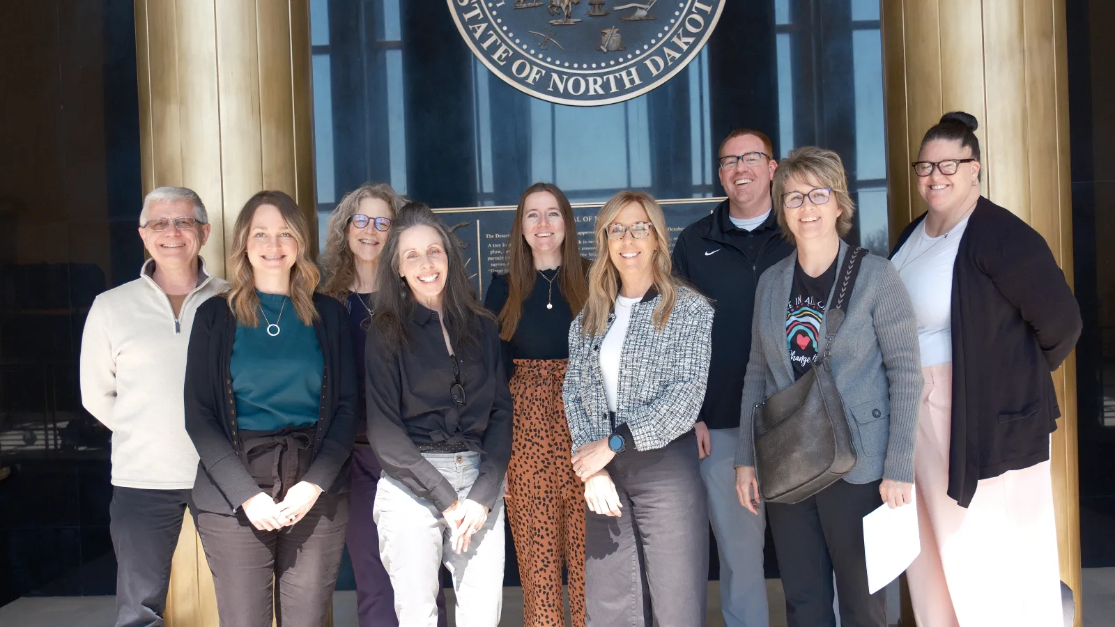group of people standing outside the nd capitol