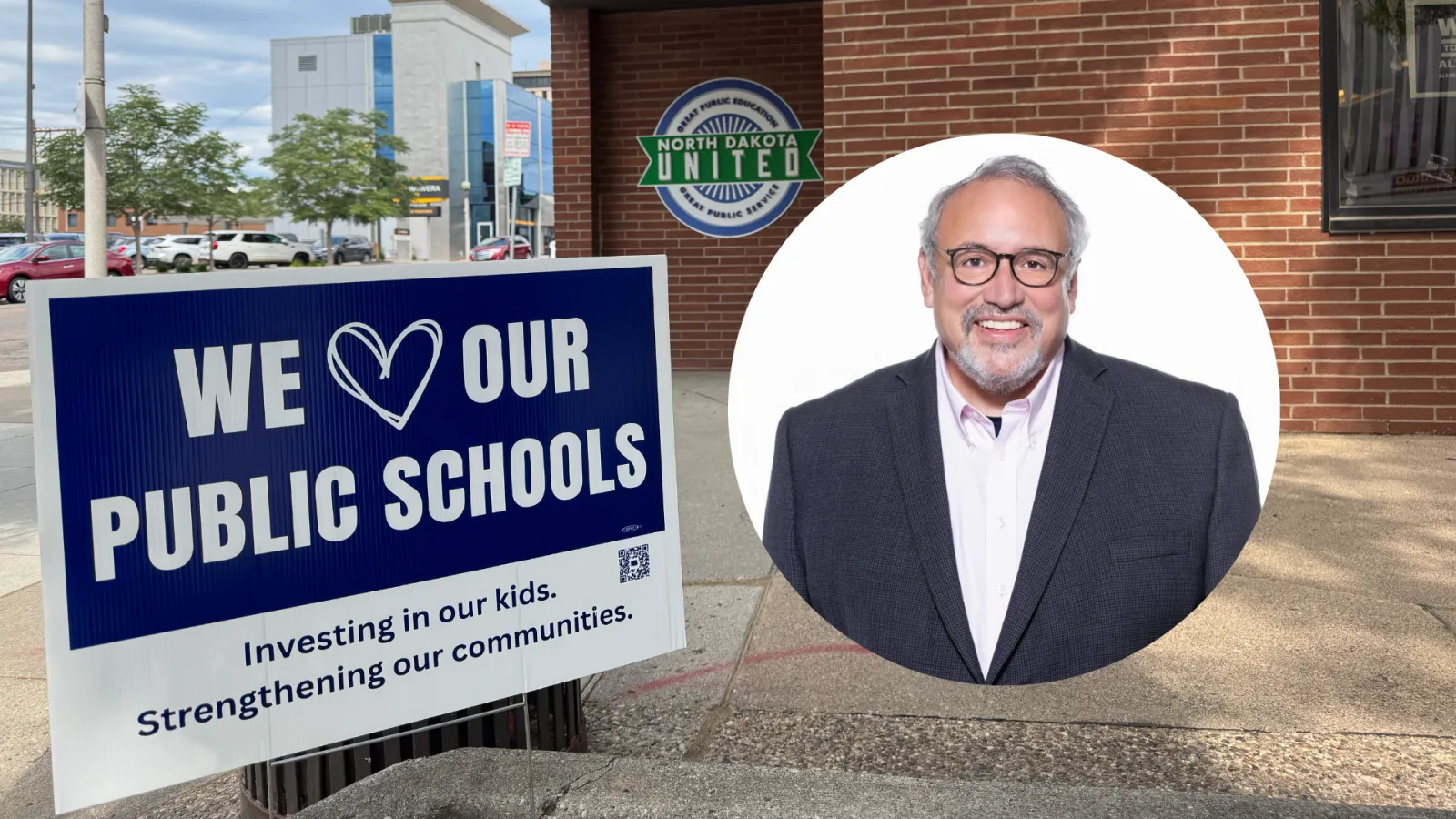 Sign that reads "We Love Our Public Schools" in front of office building with North Dakota United logo on the wall, along with circular photo of man in glasses, smiling and wearing a black suit with white collared shirt.