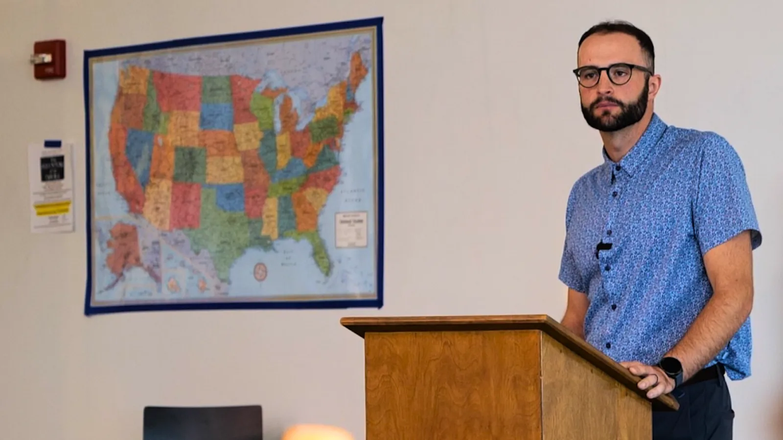 History teacher Landen Schmeichel looks out at his class from behind a podium at Legacy High School in Bismarck.