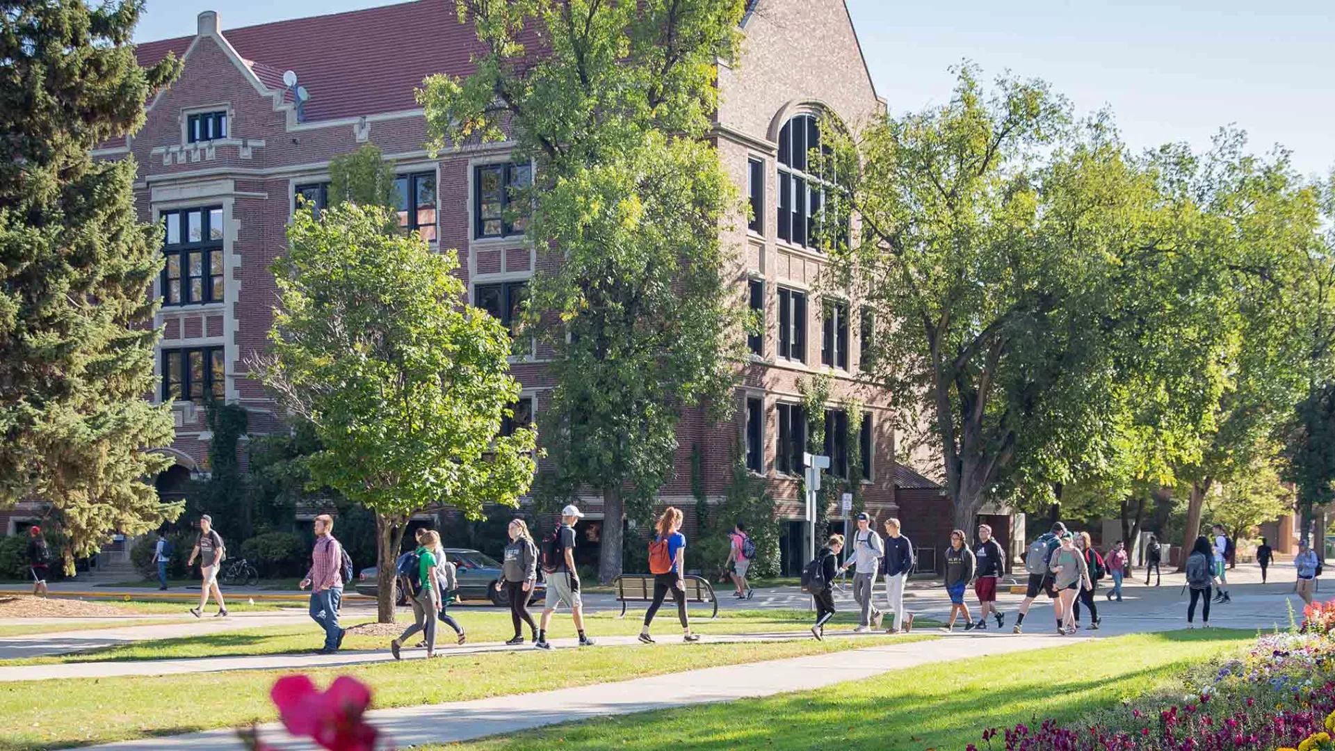 students walking around UND campus in the summer