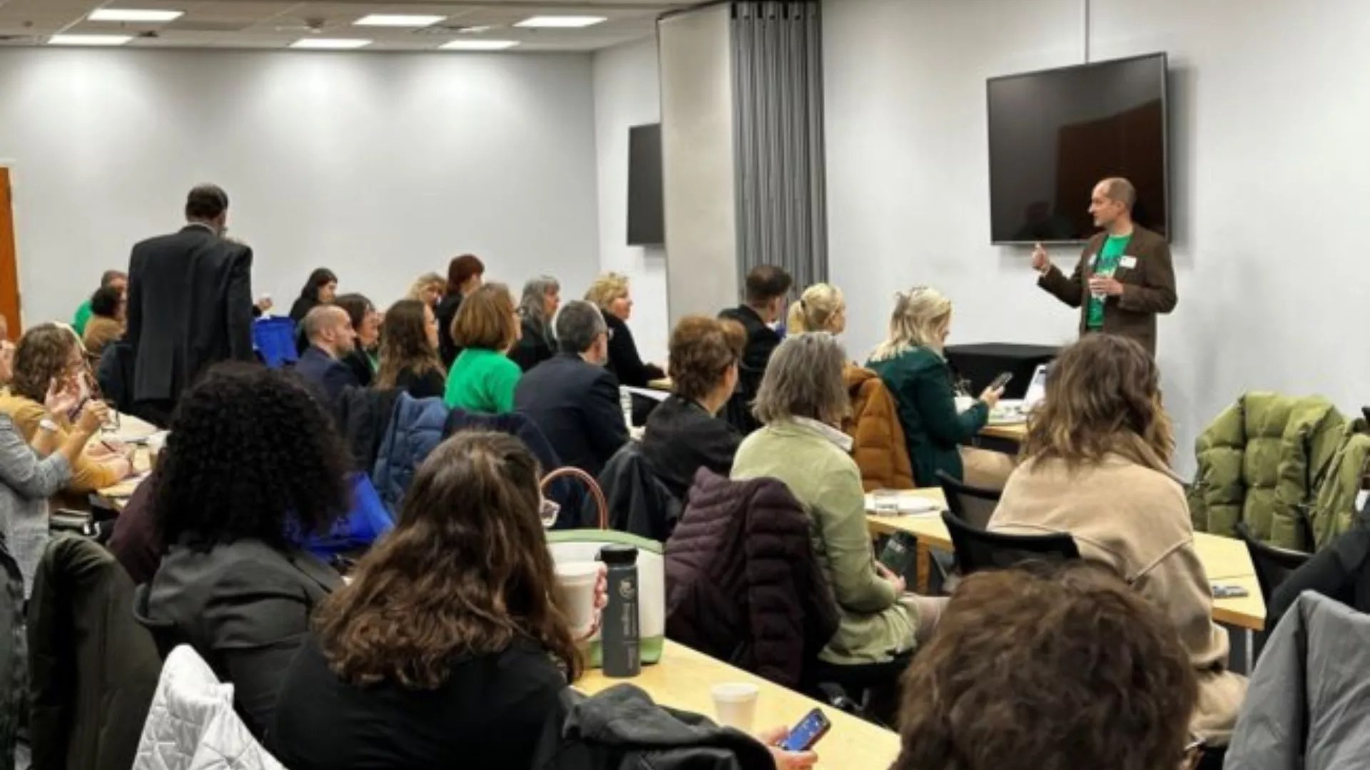 man standing in front of room giving a presentation