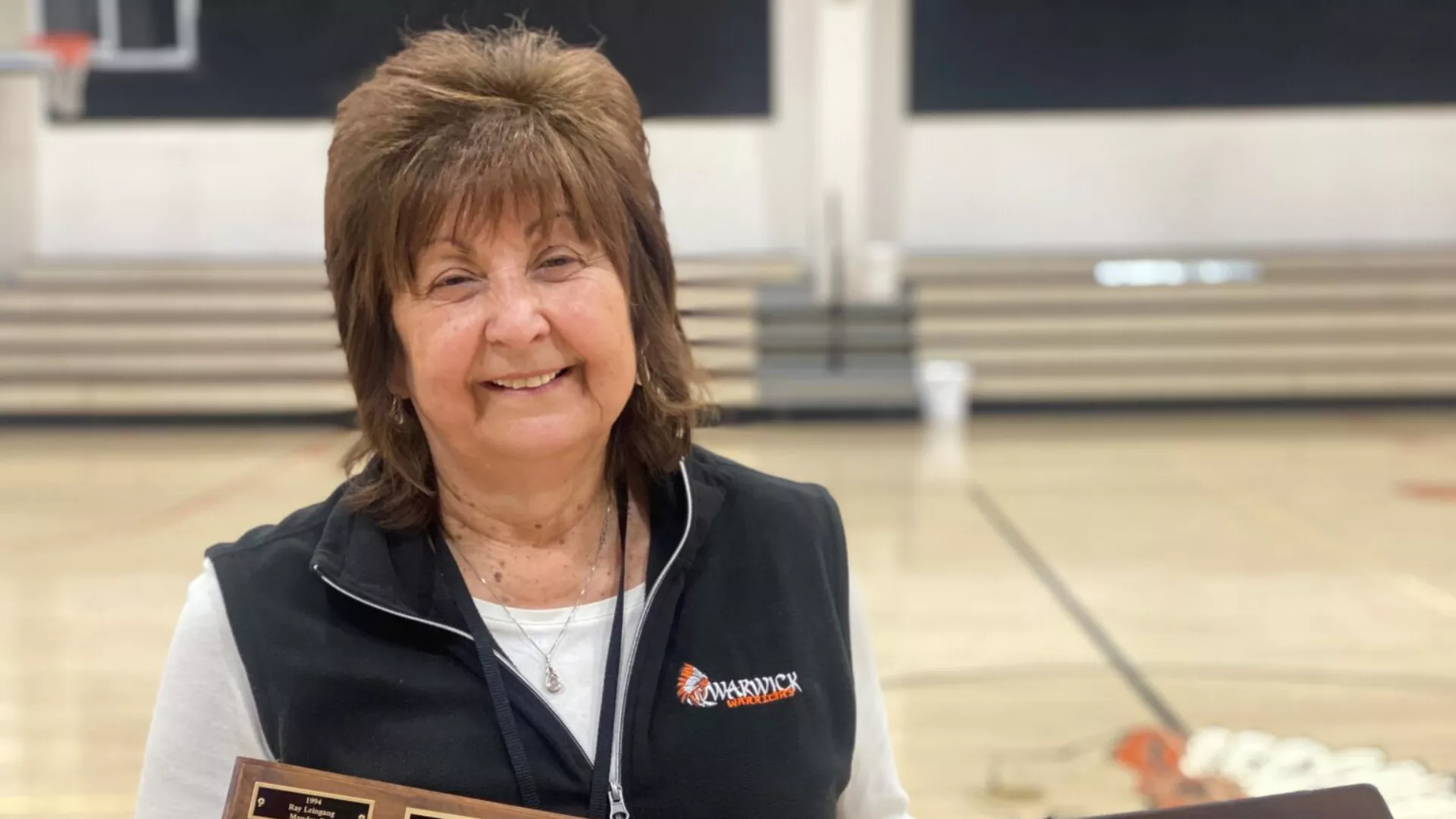 woman holding award plaque