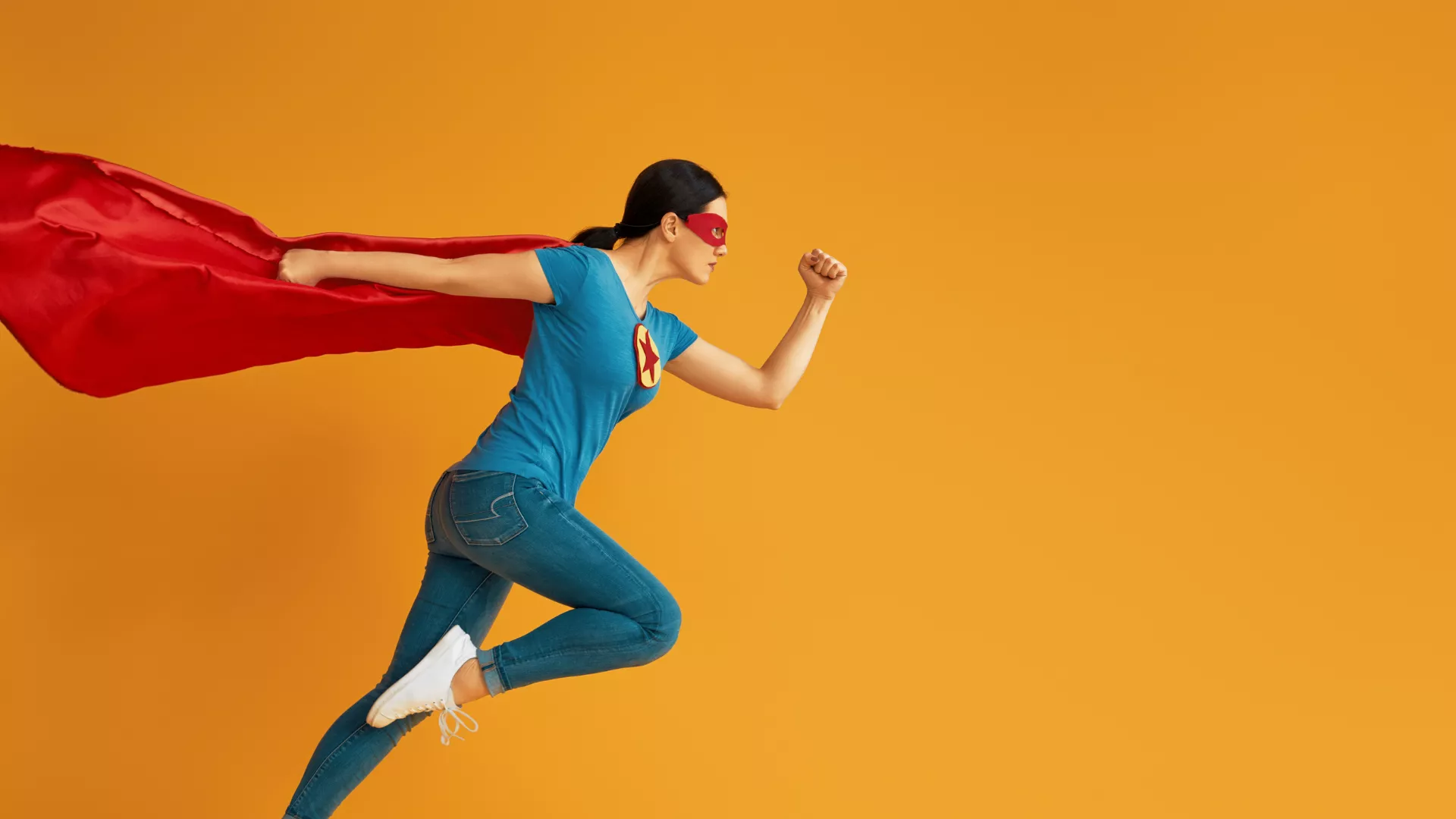 woman wearing cape running