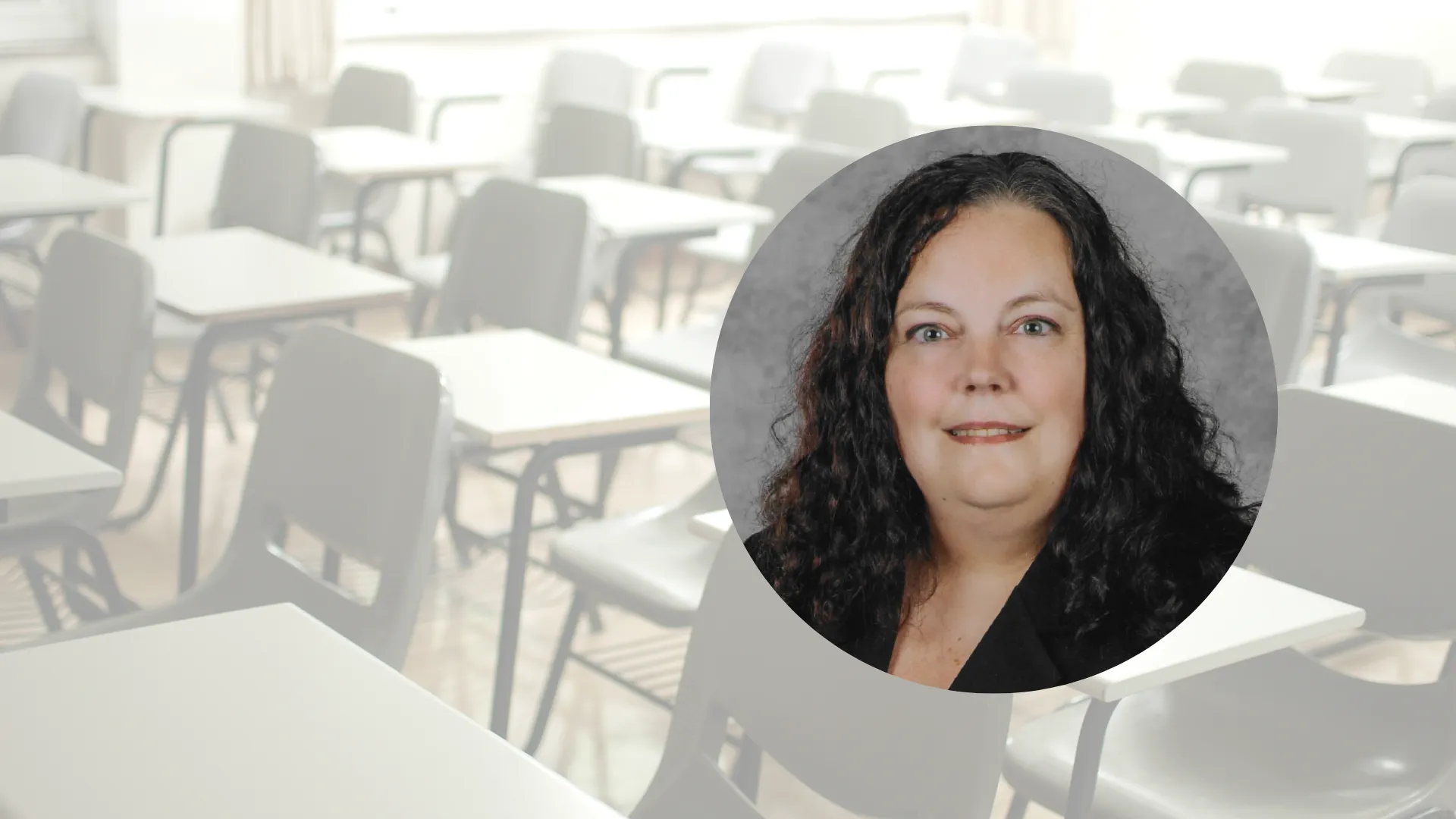 Circular photo of a woman with long, brown hair in black blazer, set atop background image of empty classroom desks in a row.