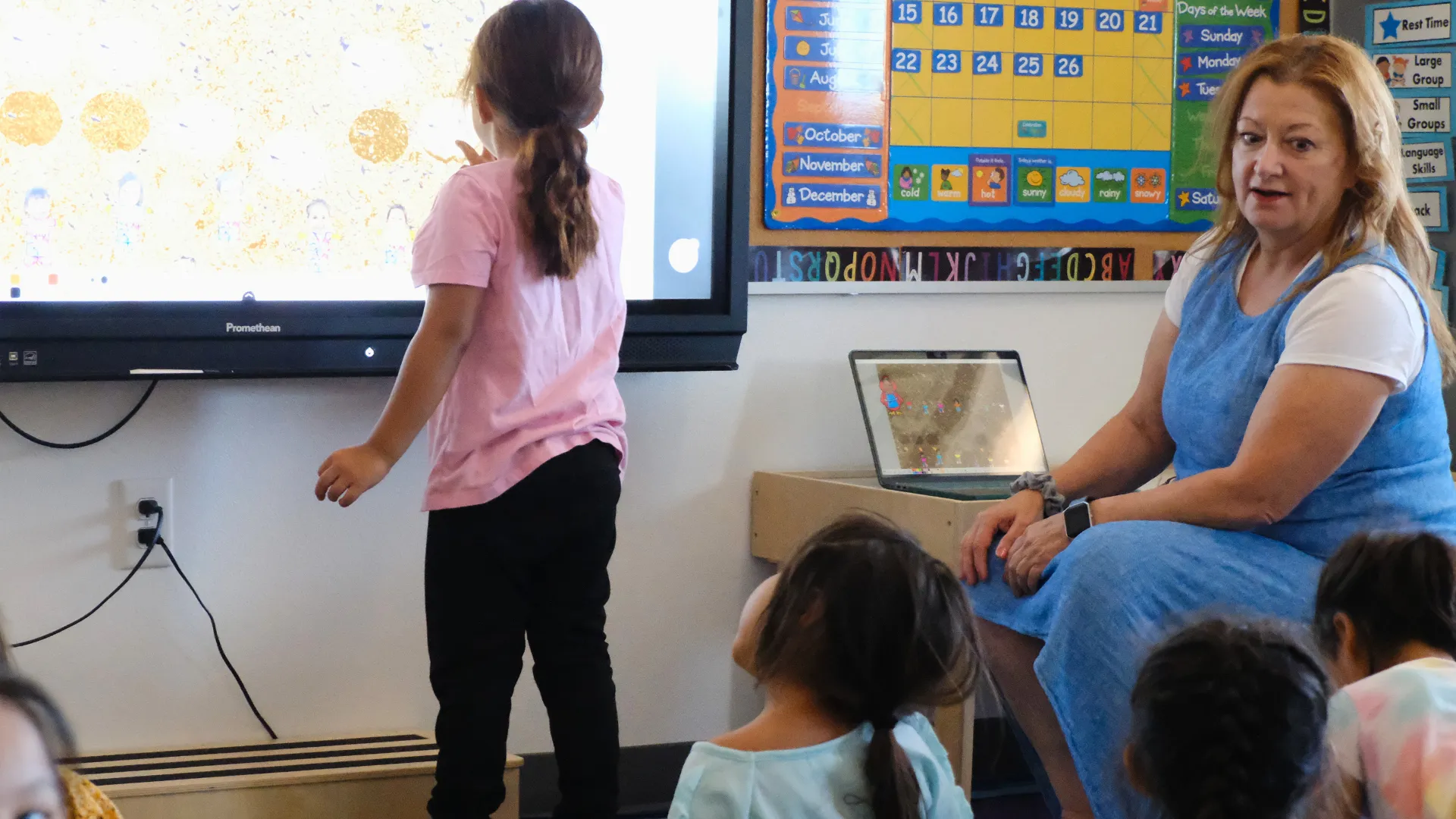 Education support professional working with students during a classroom activity.