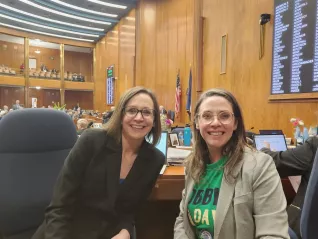 Two women sitting on the floor of the ND Capitol