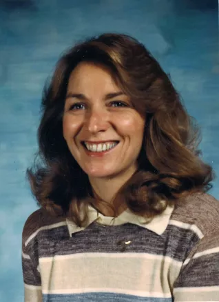 headshot of woman in the 1980s wearing a sweater