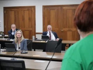 woman speaking to legislators