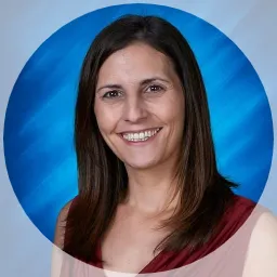 Woman with long hair standing in front of blue background