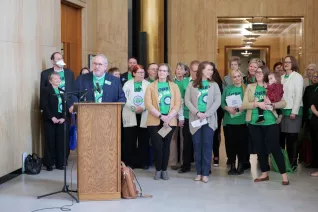 group of people speaking at the ND Capitol