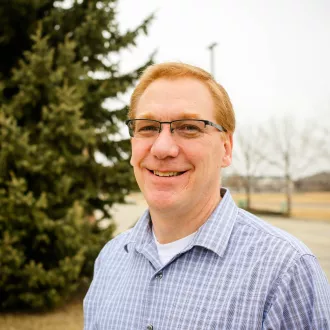 North Dakota United Vice President for Public Employees Gary Feist standing outside.