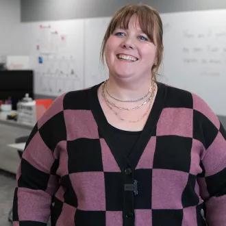 Alexis Rassett smiling in her classroom