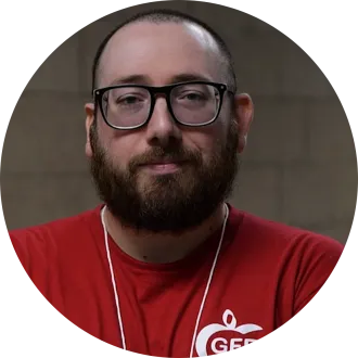 Man with glasses and beard wearing red t-shirt that reads "GFEA"